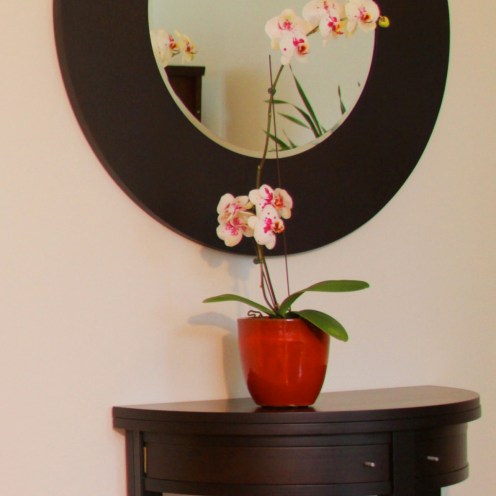 This entry foyer expresses the Asian simplicity of this residential remodel. The entry table and mirror are from Italy by Porada.