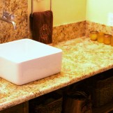 The new guest bath has warm natural tones with granite counter tops, stained birch cabinet and porcelain tile floor in soft gold tones.